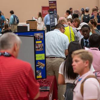 Students of Troy University meet with potential employers at a career fair.