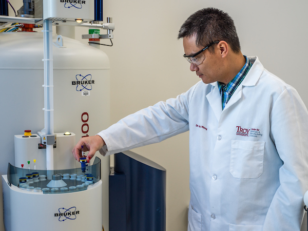 Dr. Wang using a new instrument in the CMMS building