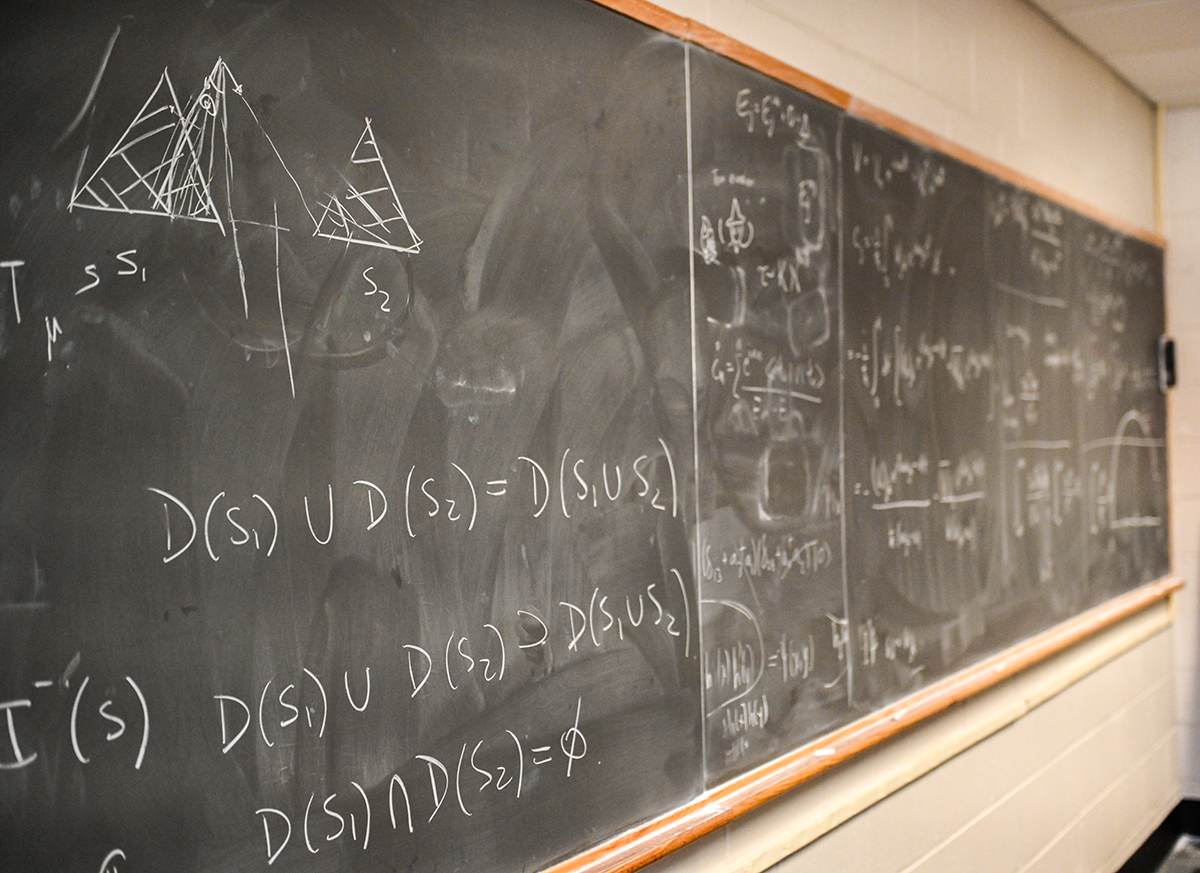 Mathematical equations on a chalkboard