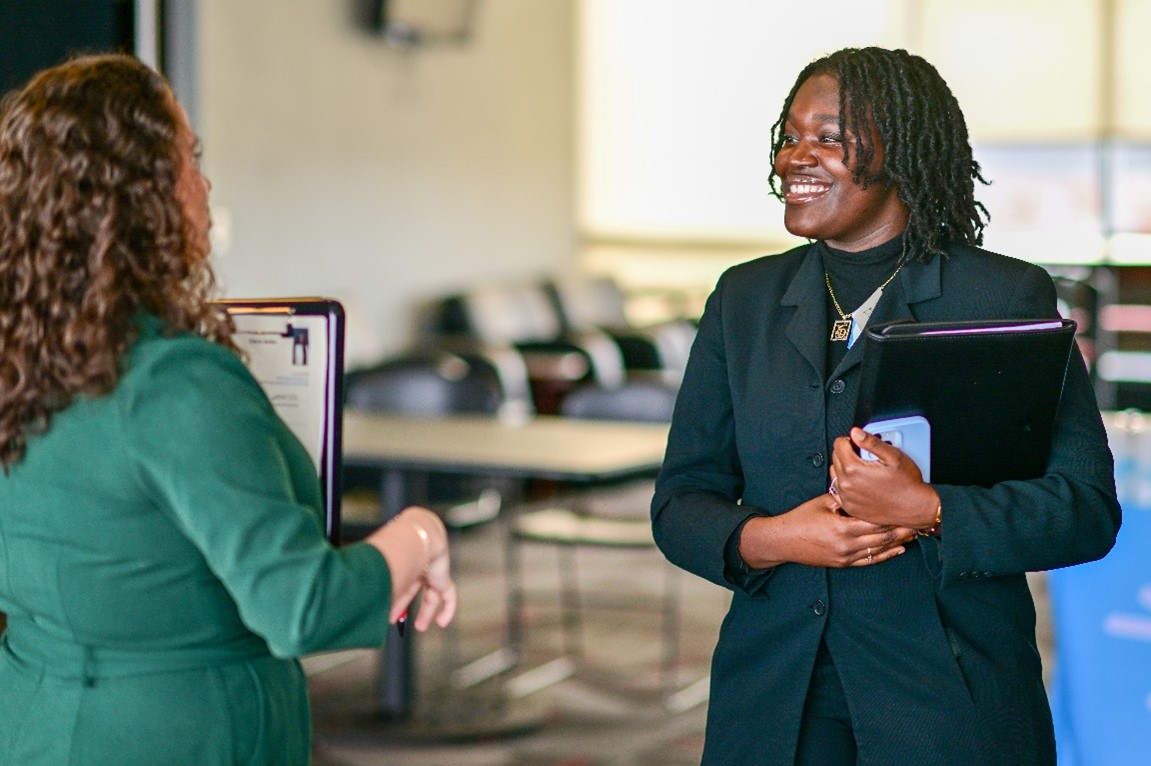 TROY professor speaking with a student