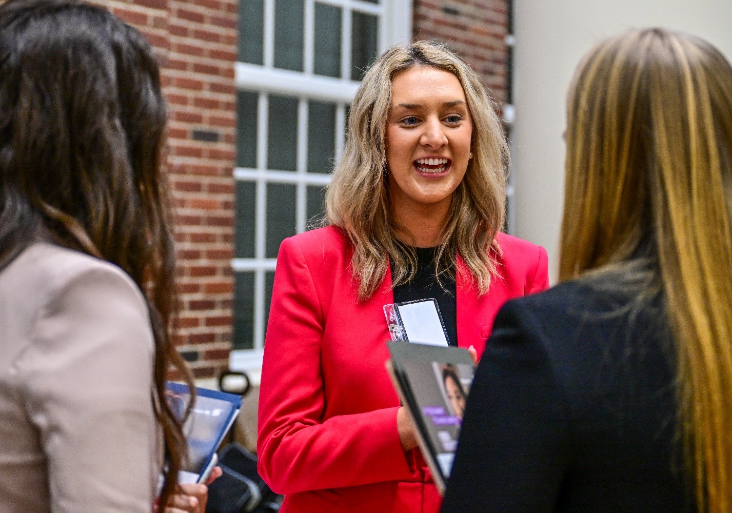 TROY alumni speaking with students at a career fair