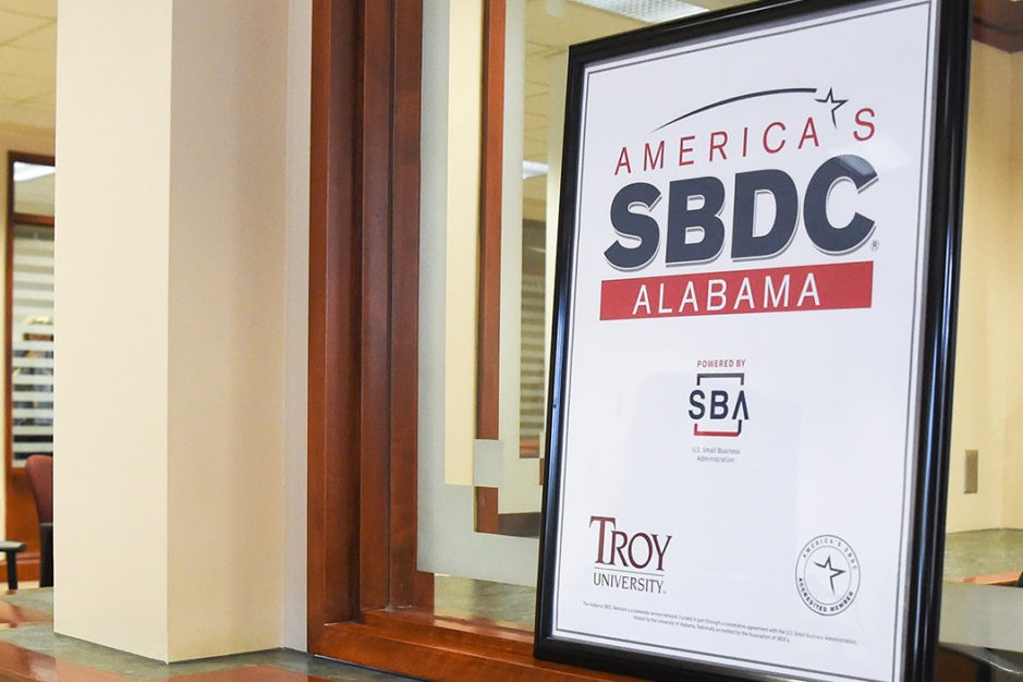 Americas SBDC Poster in front of window. 