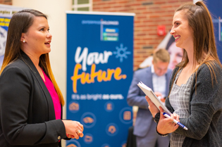 Two Troy University Business students chatting in John Robert Lewis Hall