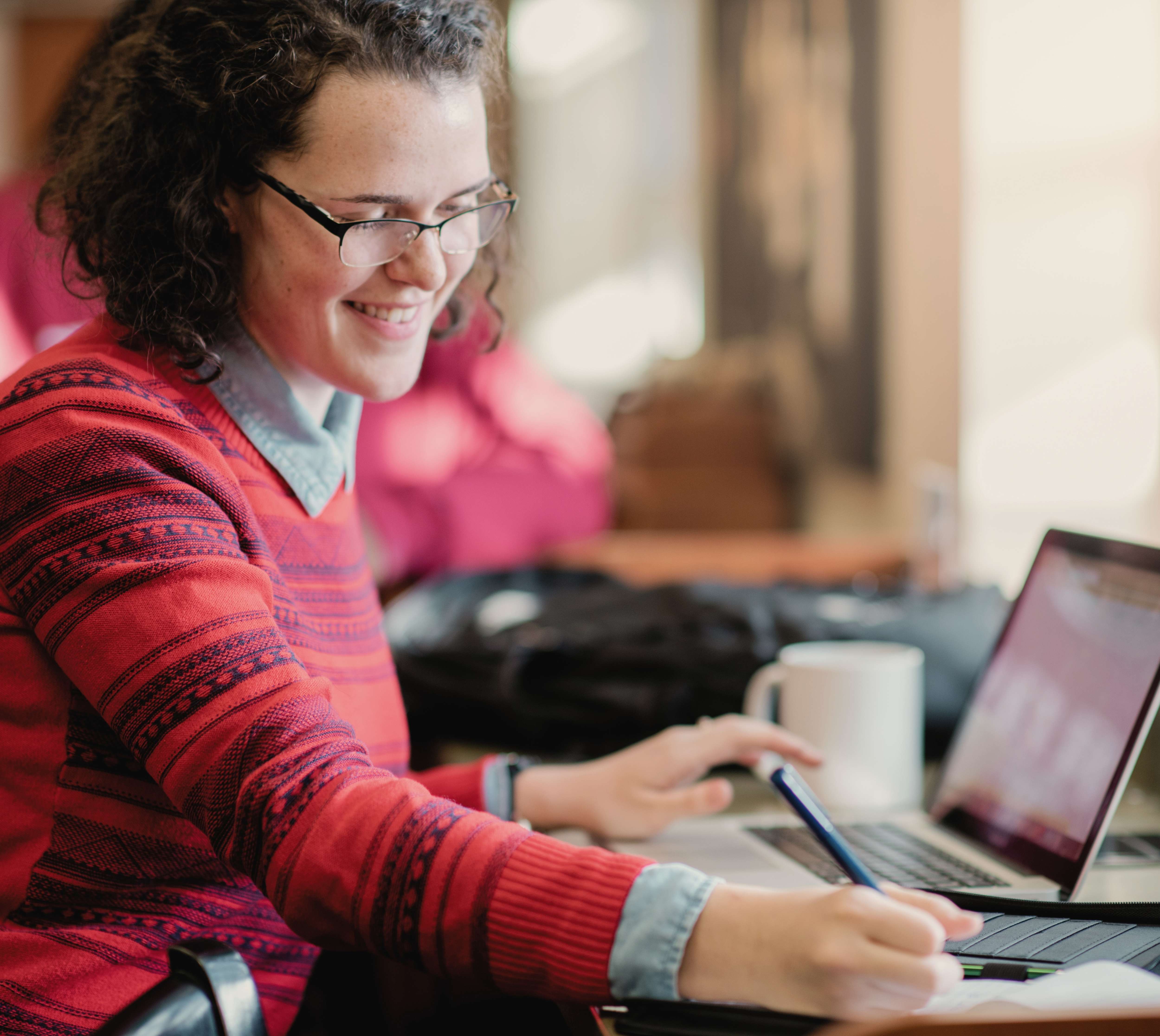 TROY student working on a laptop 