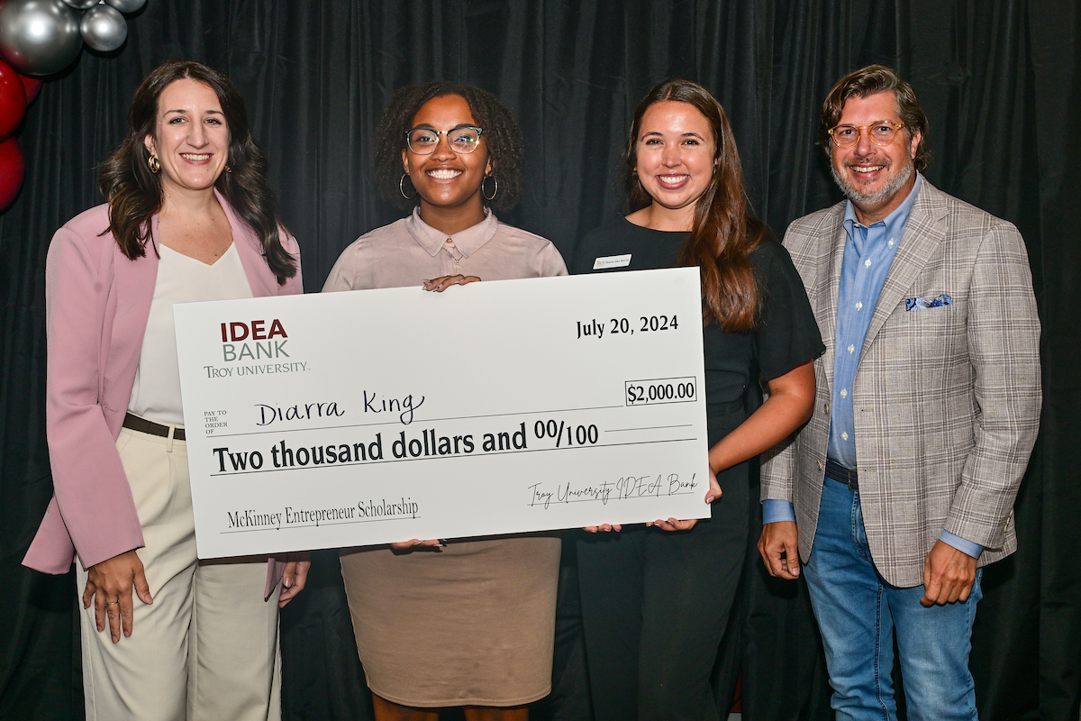 Student taking photos of the product she created for Student Made store