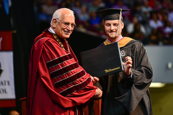 Graduate with Chancellor Hawkins at commencement