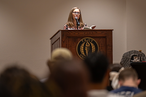 Horne reading book aloud at event 