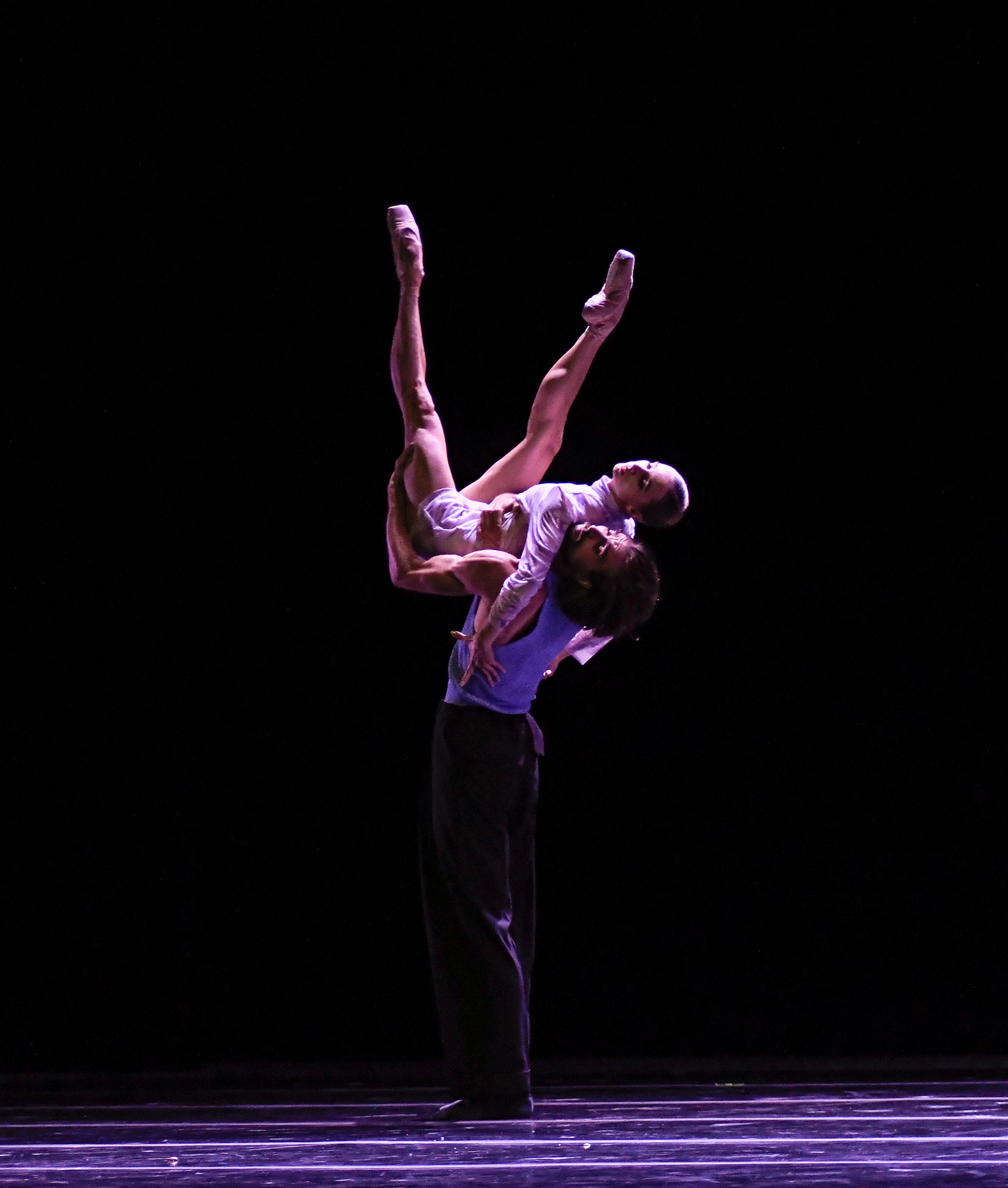Dancers, Kotchetkova and Kloborg, Kloborg is lifting Kotchetkova into the air on stage.