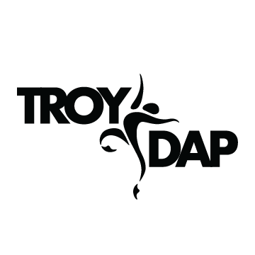 TROY Dap Logo with a dance figure in between the words