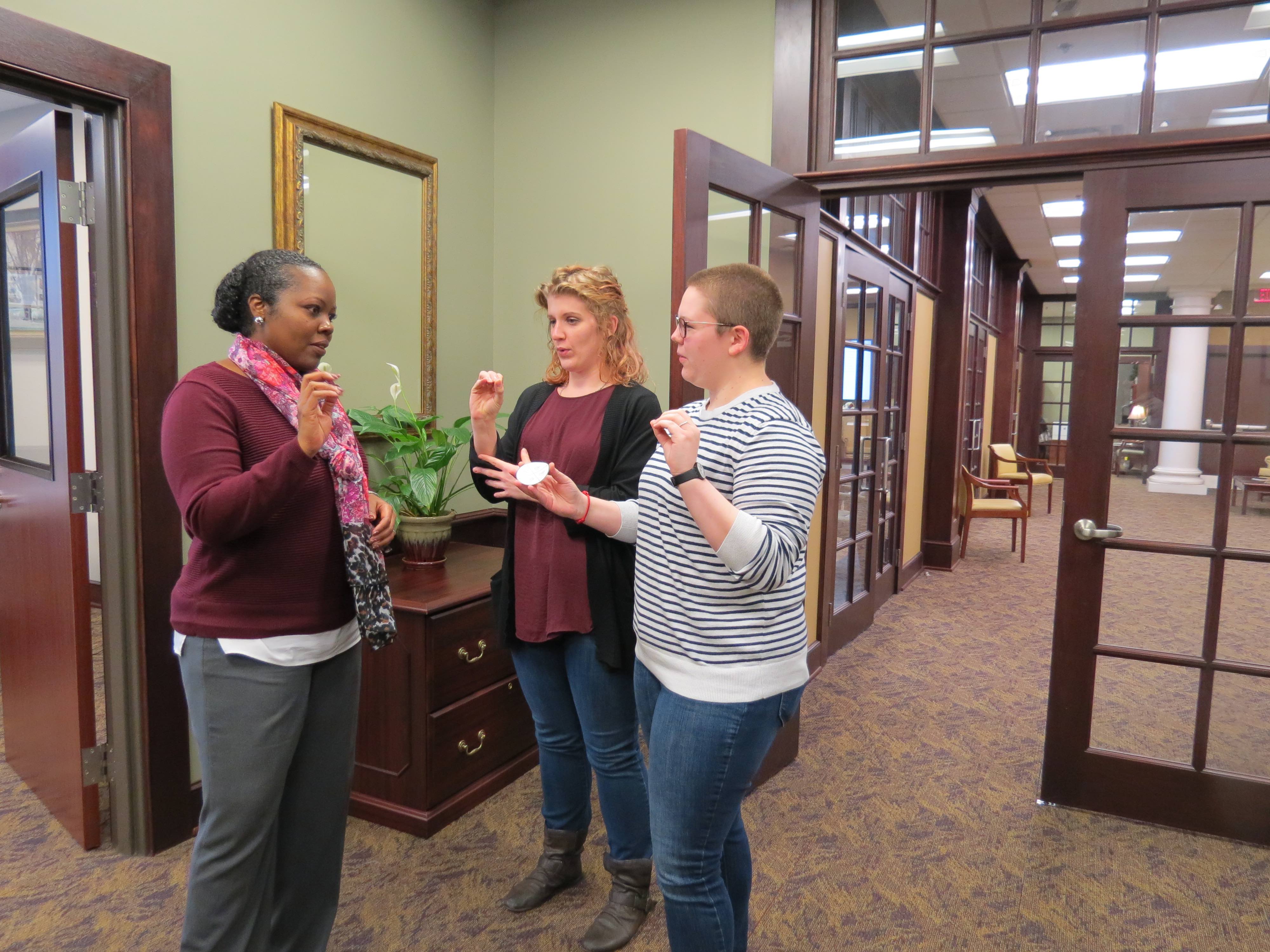 Dean interpreting finger spelling T R O Y with ASL/ITP club members