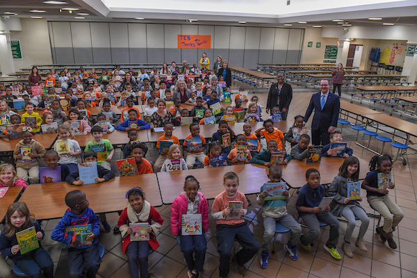 Troy University faculty with elementary school students. 
