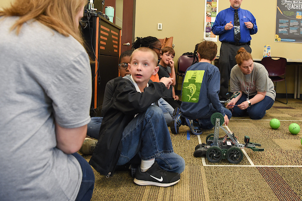Troy University students working with children in the classroom. 