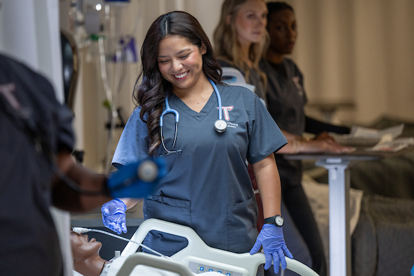 BSN Students in scrubs enrolled in the TROY nursing program.