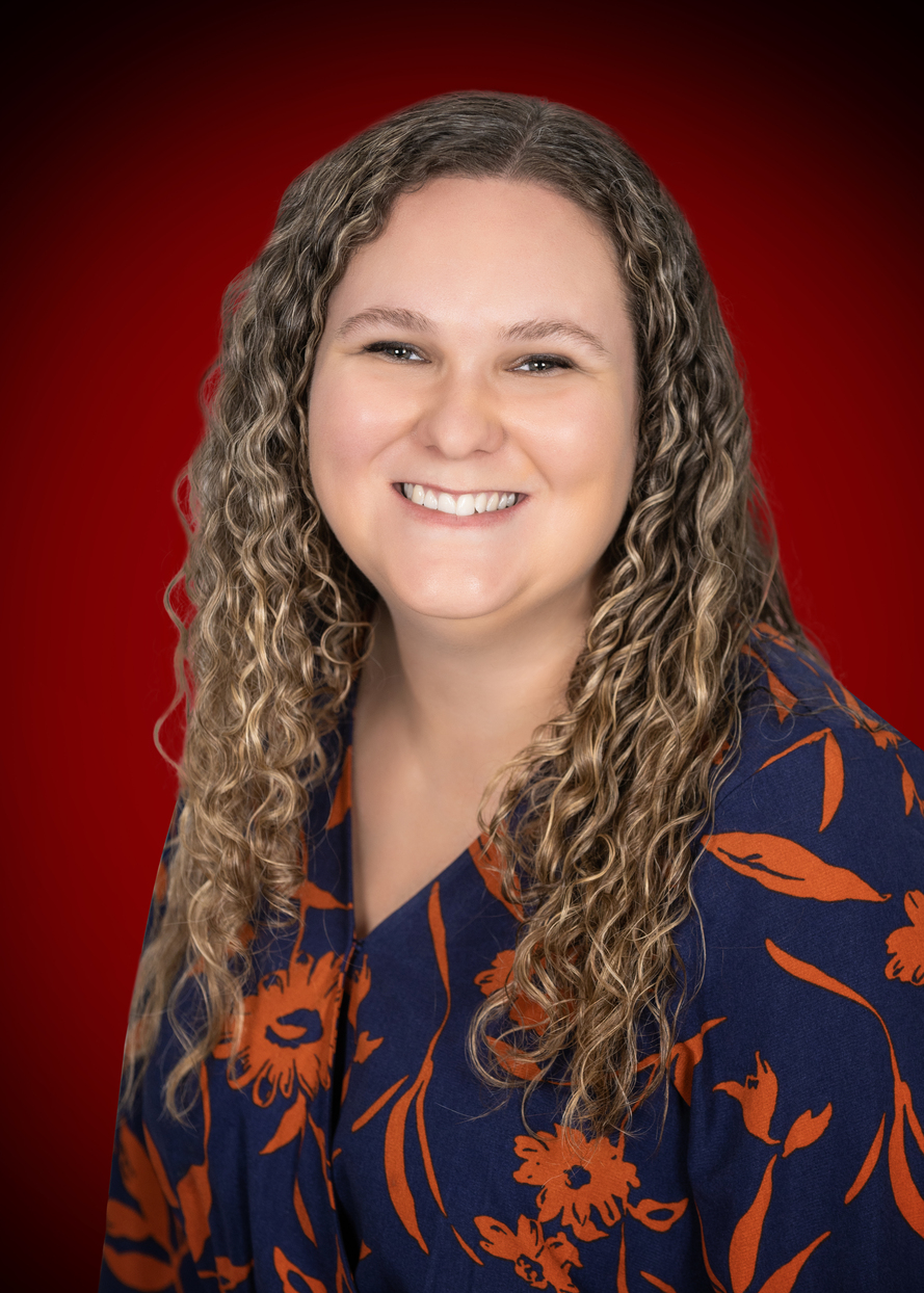Hannah Picazo standing infront of red background