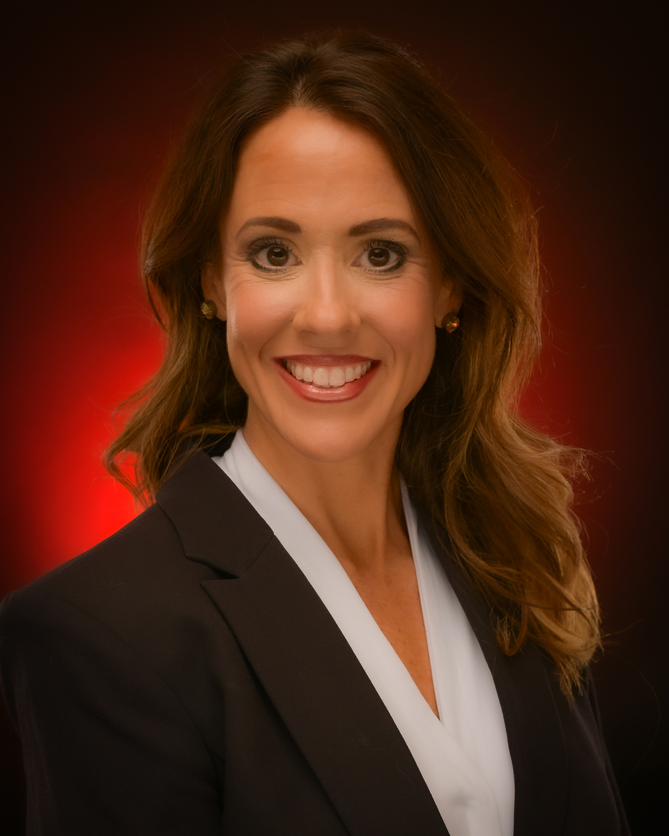 Megan Collins Headshot with red background
