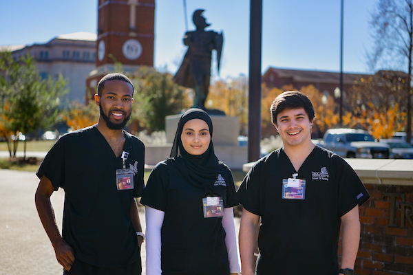 Troy University ASN students smiling in sunlight