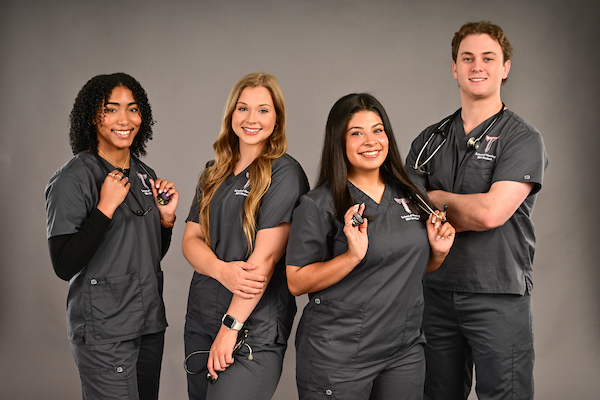 BSN Students in scrubs enrolled in the TROY nursing program