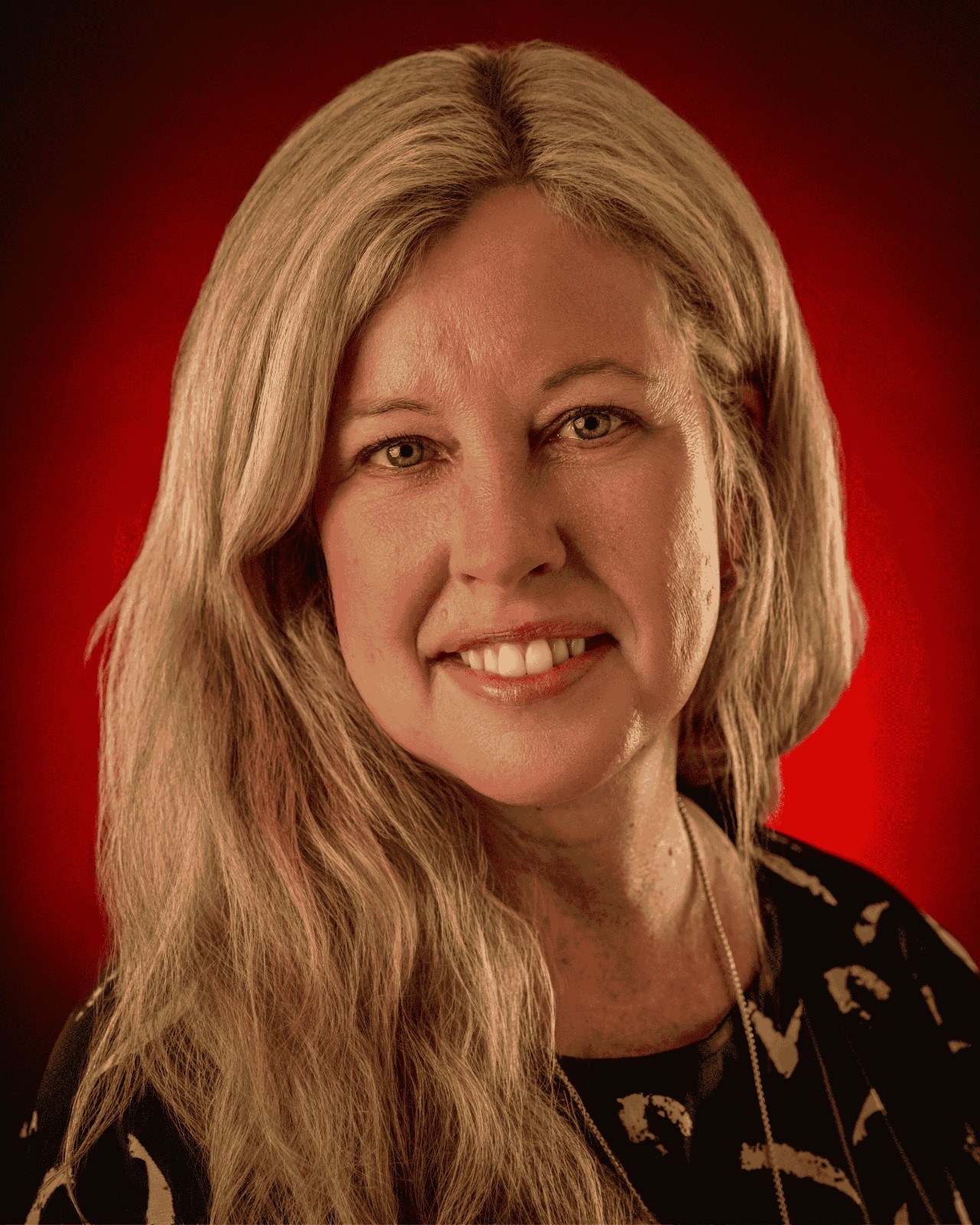 Maranda Fain Headshot photo with red background. 