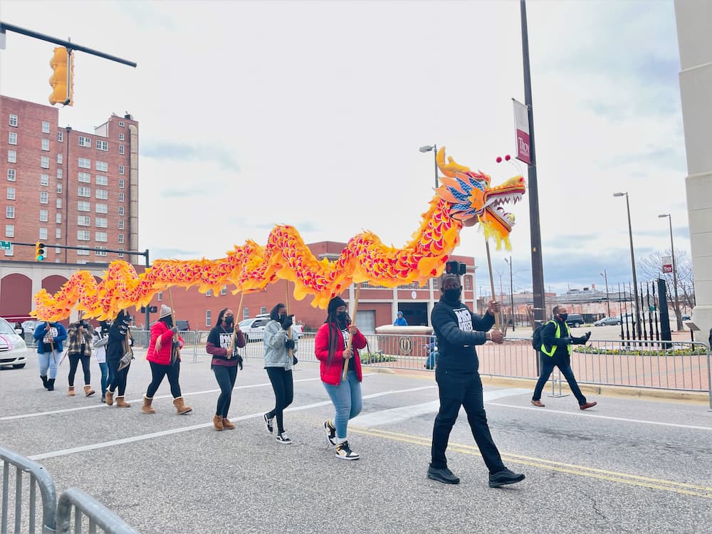 the volunteers demonstrate the basic dragon dance during the parade