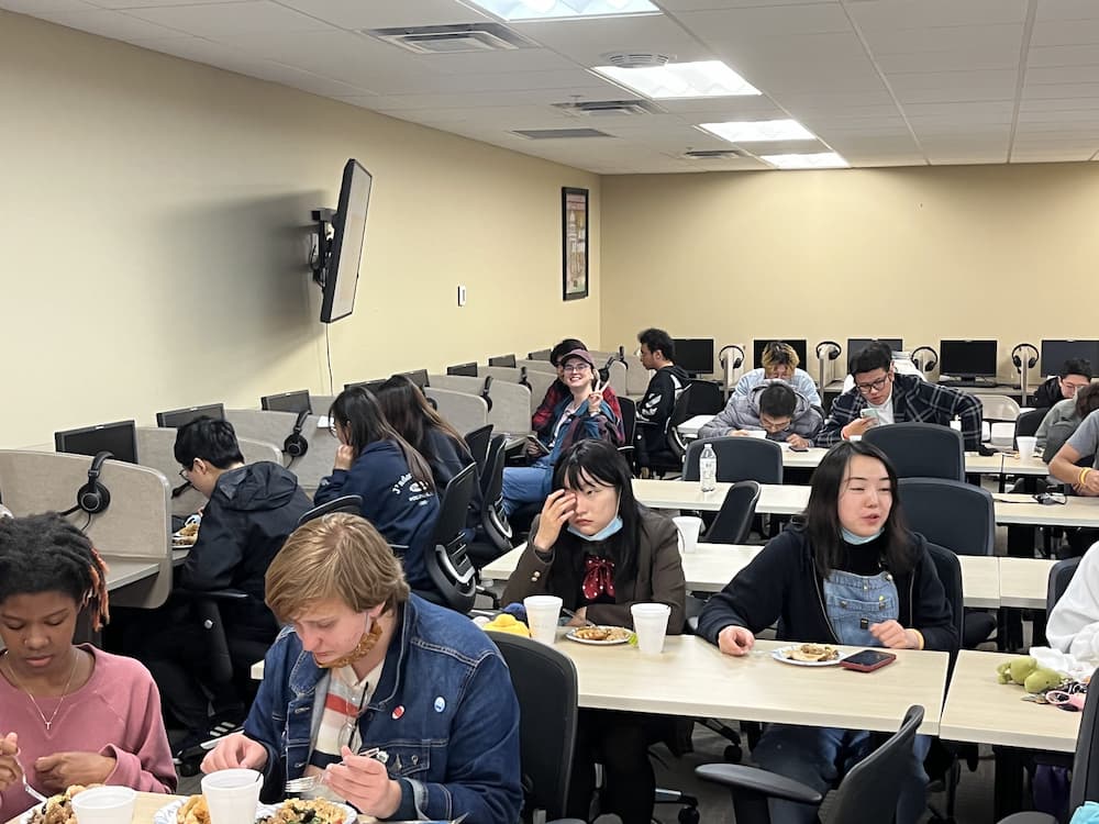 Students enjoying festive Chinese dishes