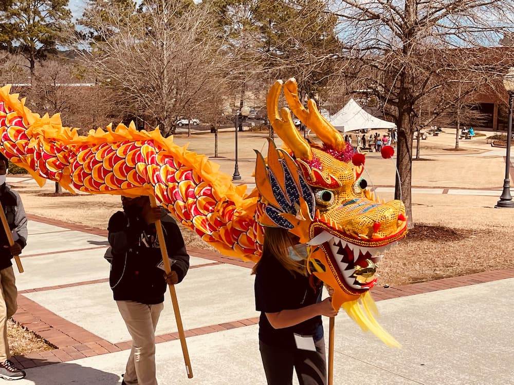 Charles Henderson Middle School students carrying the Chinese dragon costume