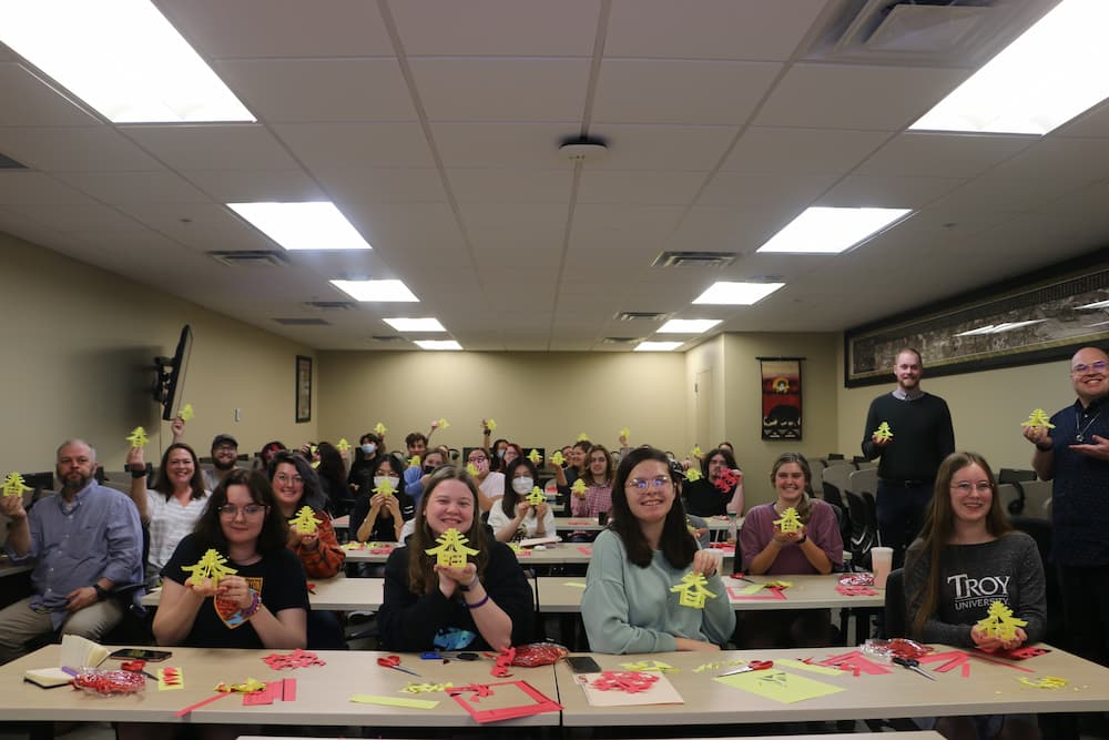 Group photo of everyone showing off their paper cuts