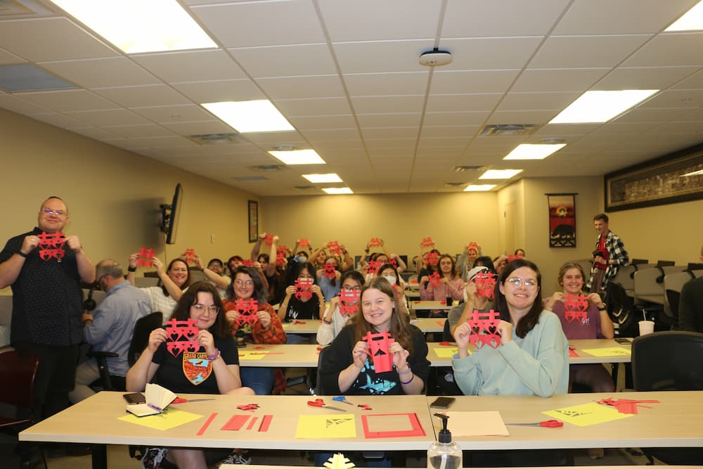 Group photo of everyone showing their double-happiness paper cut