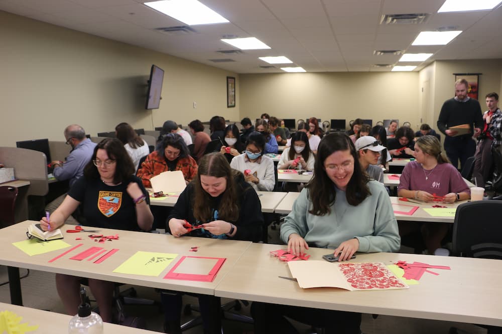 Troy students working on their paper cuts together