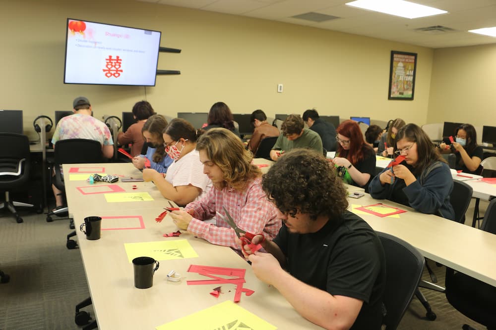 Long shot of students working on their paper cuts
