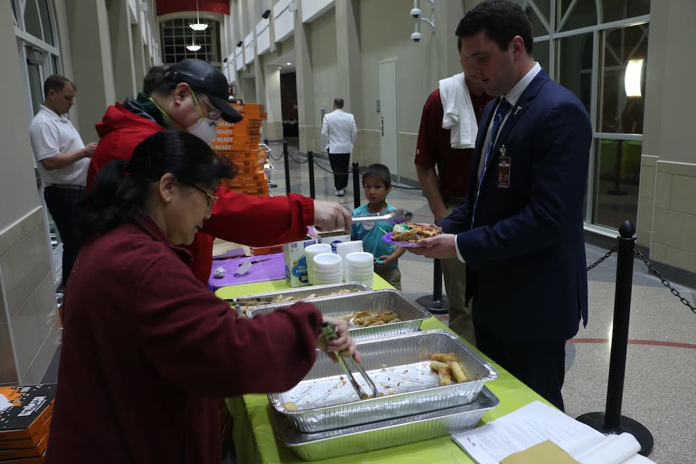 Directer Dr. Xu and Dr. Feng serving Chinese food to the public