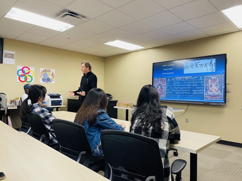 Troy students listening to the history of the Tibetan language