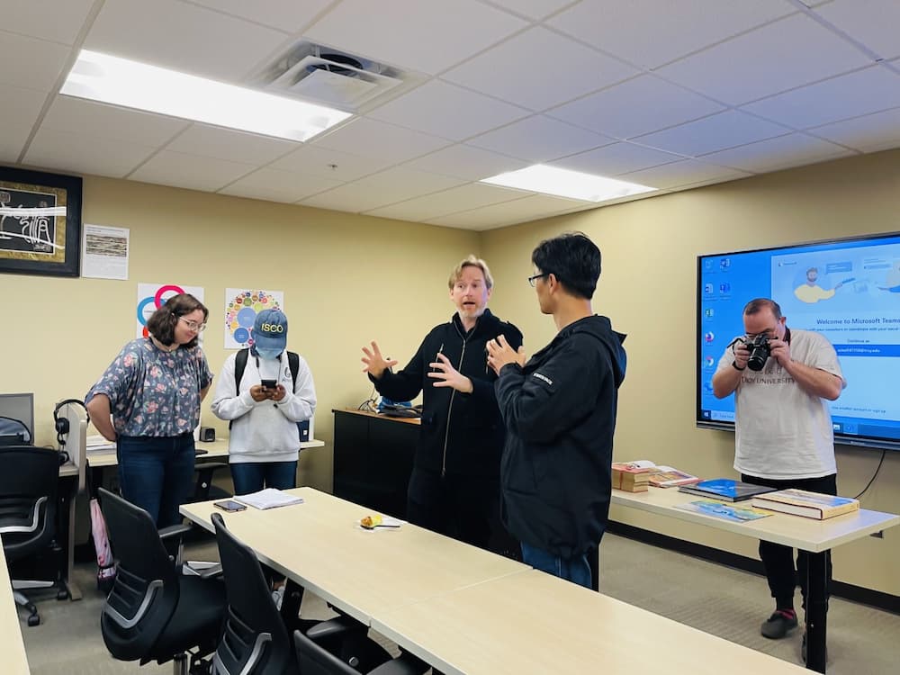 Dr. J. Valentine talking to students after the presentation and answering questions