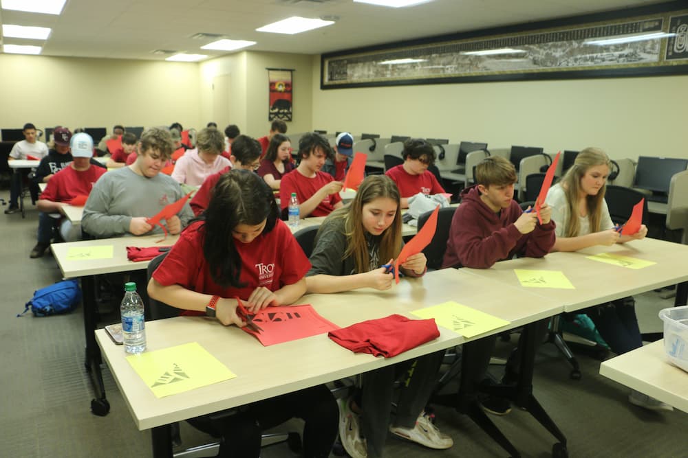 Students learning how to make Chinese paper cuts