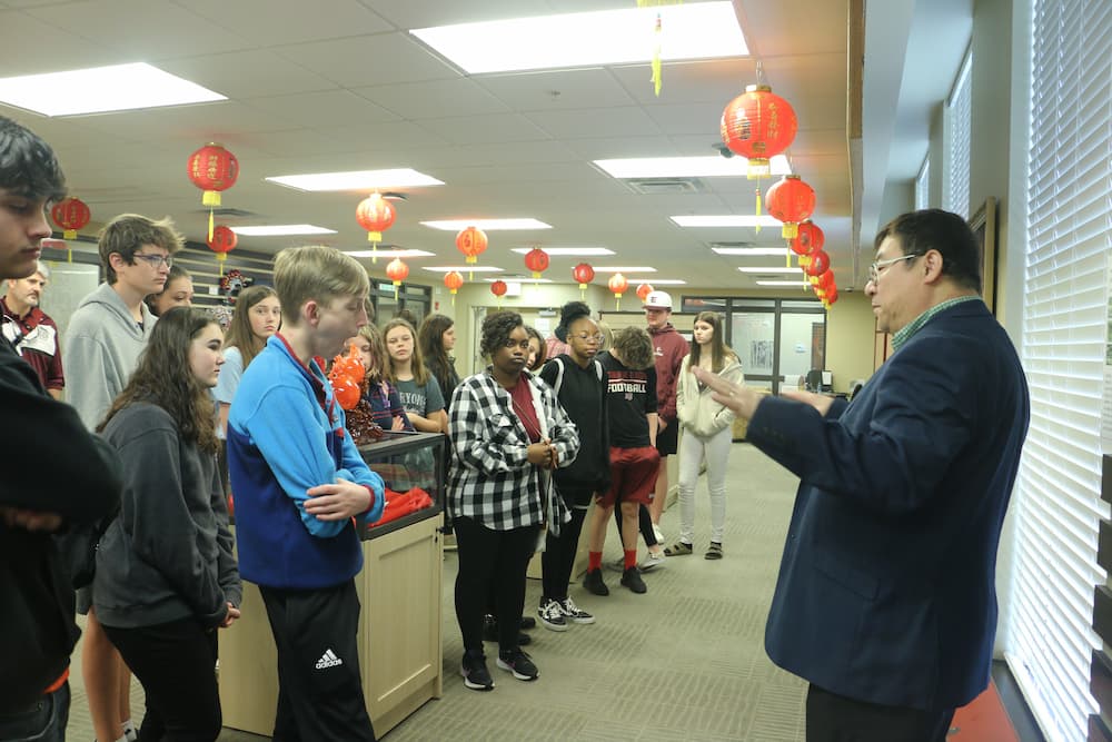 Dr. Feng giving the students a tour of the exhibition hall