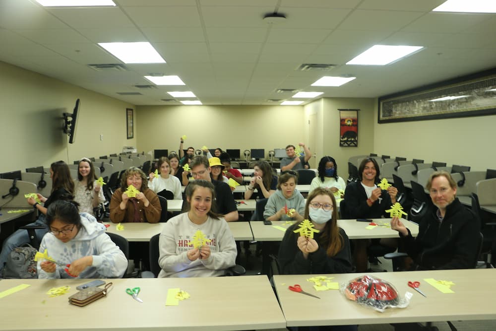 Dr. Jay Valentine's class showing off their Spring Chinese paper cuts