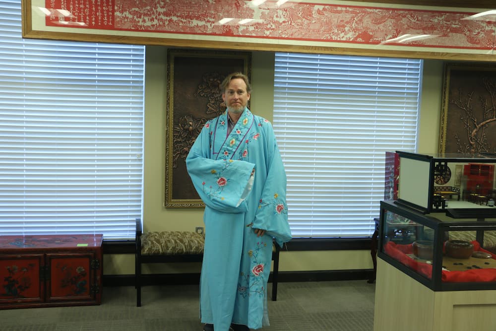 Dr. Jay Valentine dressed in a traditional Chinese robe for scholars