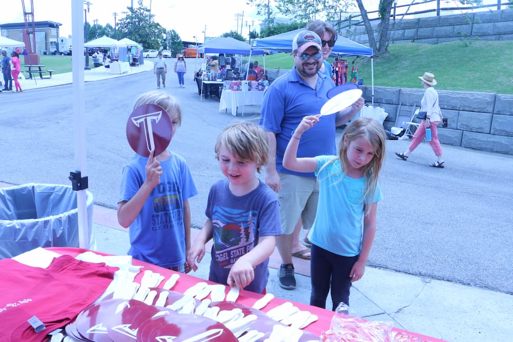 Children posing with their Troy University fans