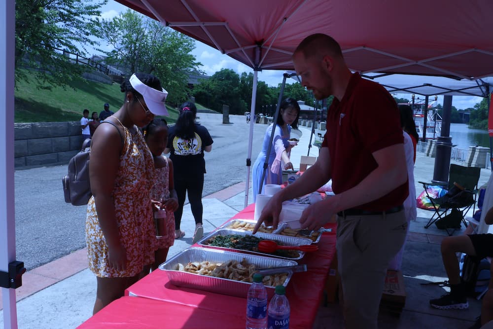 Austin Deal serving customers Chinese food