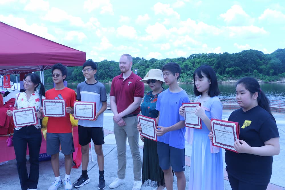 Austin Deal posing with our volunteers as they recieve their certificates