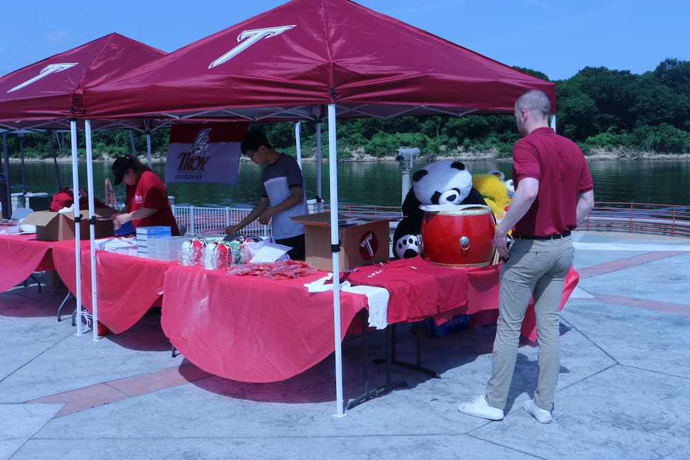 staff and volunteers help set up the tent for the event