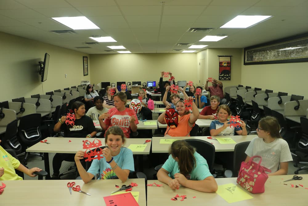 Students showing their Chinese paper cuts