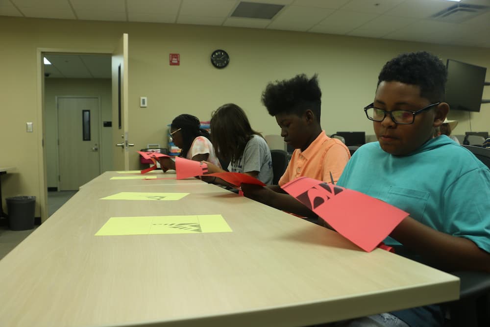 Students in the process of making their Chinese paper cuts