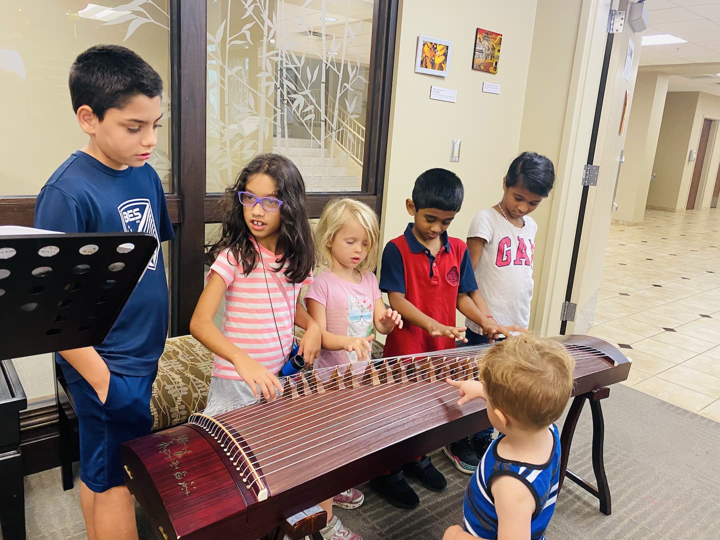 Students interact with Chinese traditional instrument Qixiang