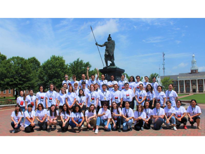 Troystar students take a group picture in front of Trojans fountain