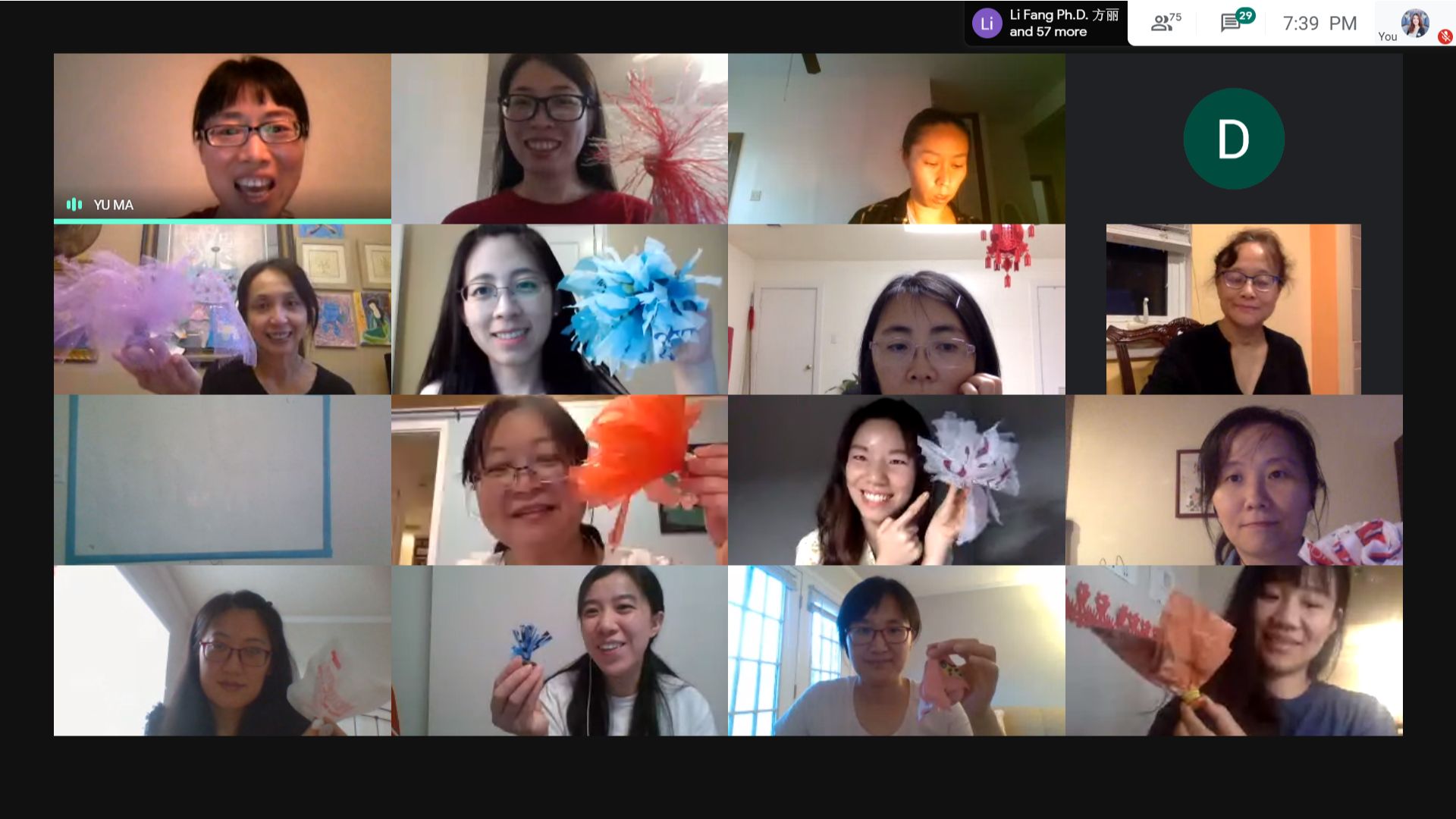The participants hold up their finished jianzi, proudly made at home.