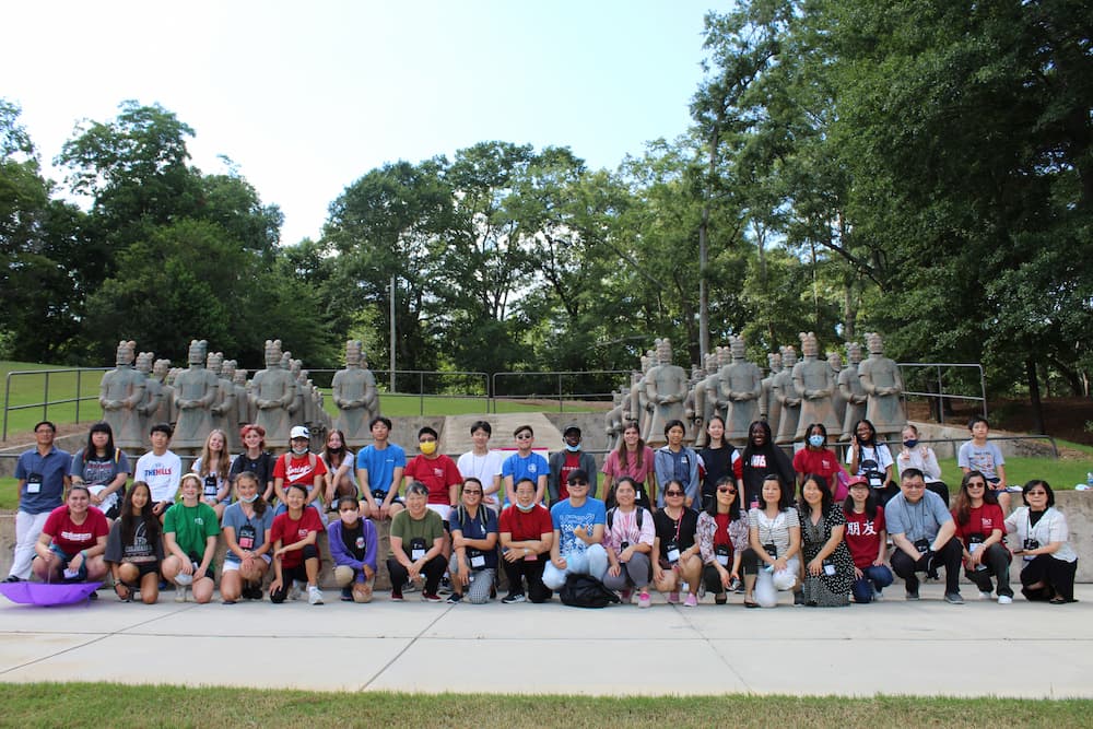 group picture of the participants in fornt of terracotta warriors