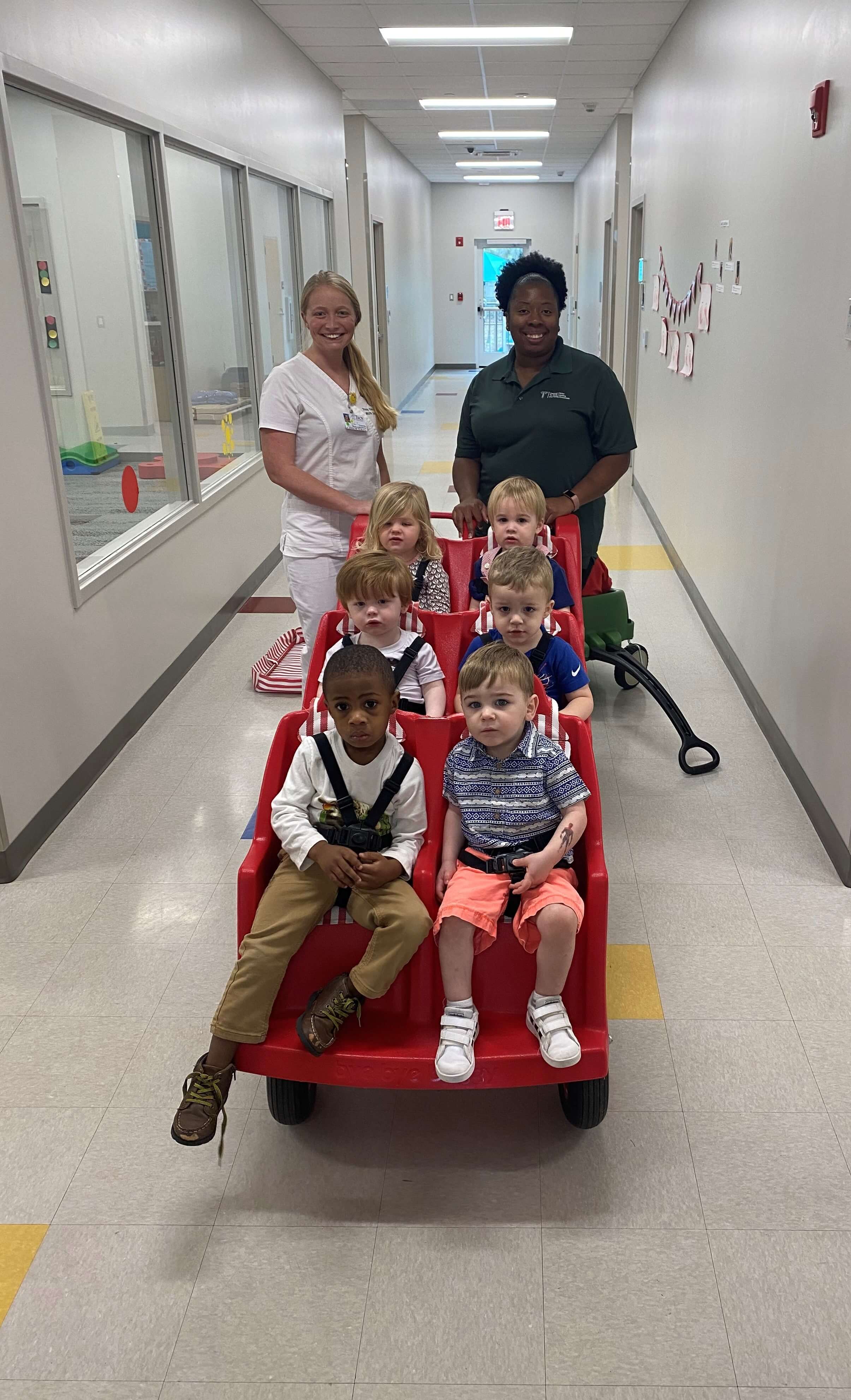 Our infants and toddlers enjoy strolling with their teacher and Troy University nursing student.