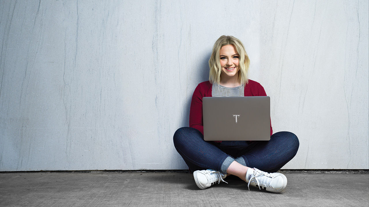 Graduate student taking an online class at Troy University.