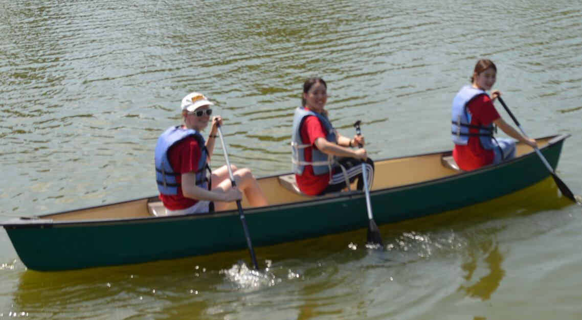 New exchange students canoeing at Camp Butter and Egg during Orientation