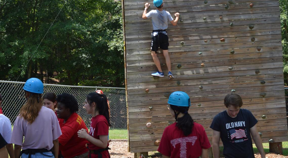 New students climbing the wall at Camp Butter and Egg during Orientation. 